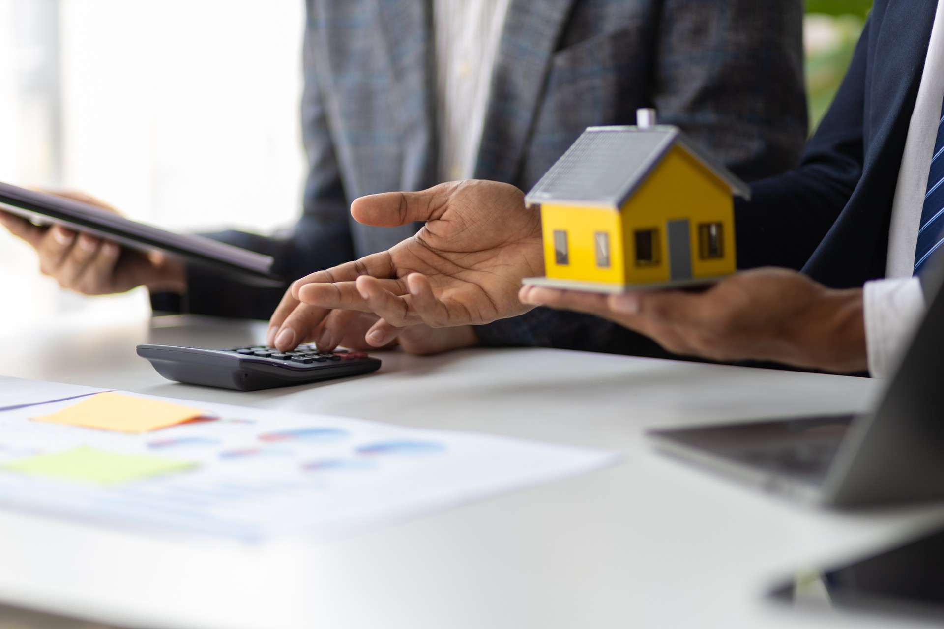 Businessman are meeting to discuss the returns of real estate investments. Real estate investment concepts, cash flow, rent, mortgages, house and land appraisals.